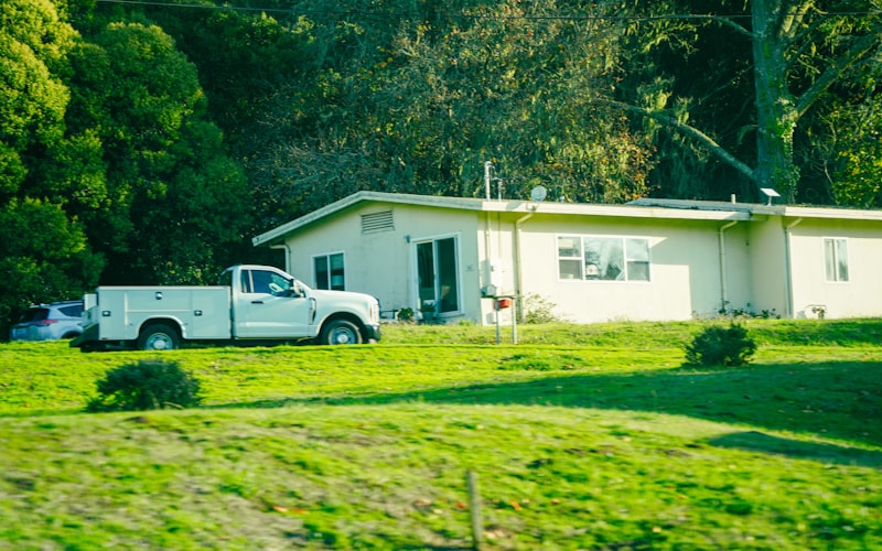 White service truck parked outside a residential home