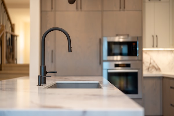 Modern black kitchen faucet on marble countertop